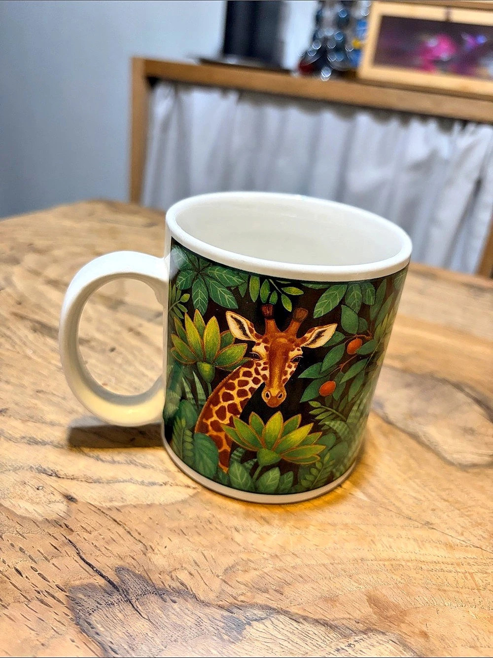 The Sakura Table Giraffe Jungle Mug in Green & White holds 10 ounces